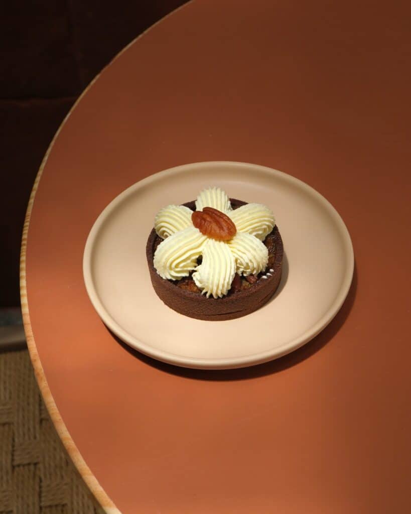 Pecan Tart with chocolate shell, cream petals and pecan at Dulce de Saigon