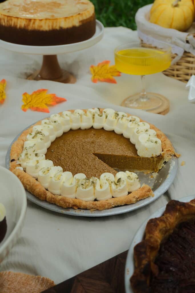 Whole Pumpkin Pie with a piped cream border at Dulce de Saigon