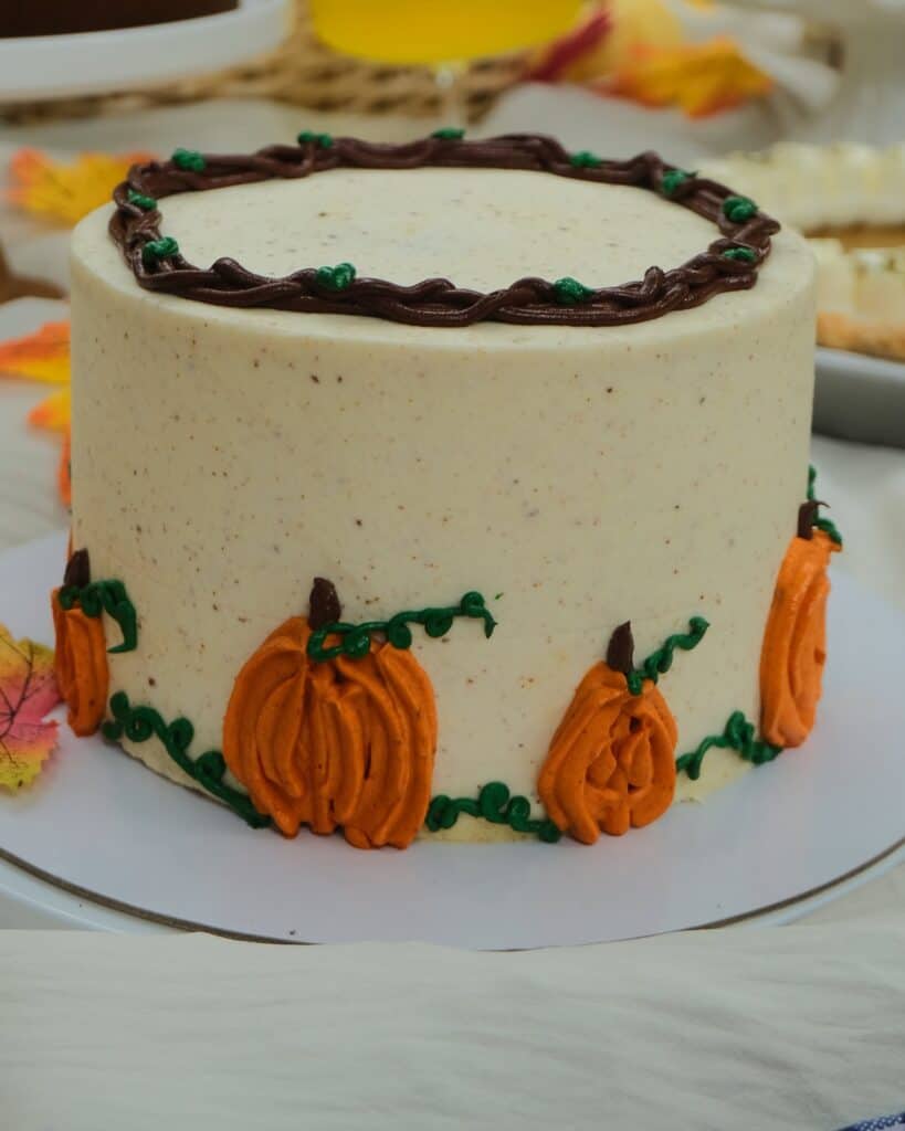 Whole Pumpkin Spice Cake with brown butter frosting and piped pumpkins at Dulce de Saigon